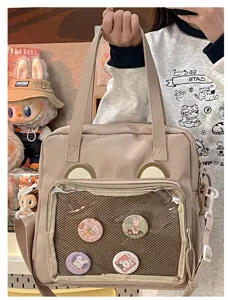 Detailed view of the cute bear ear ita bag with mesh pocket for anime pins and badges.