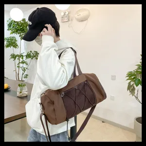 Detailed shot of brown gym duffel bag with mesh pocket and strap in indoor scene setting