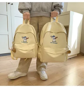 Detailed view of the cute puppy embroidered canvas backpack with large capacity for students.