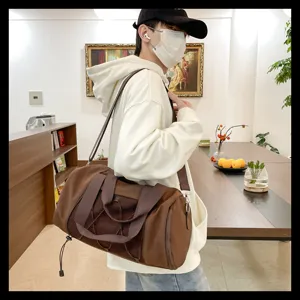 Detail view of brown sports gym duffel bag, large capacity travel bag for fitness and sport.