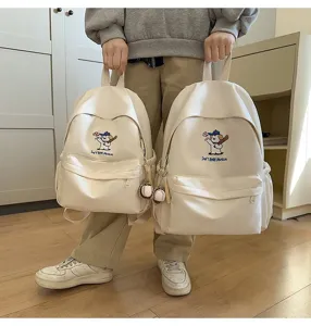 Detailed shot of canvas school backpack with cute dog embroidery, large capacity daily use.