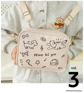 Canvas crossbody bag detail showing cute cat dog doodle print and adjustable straps