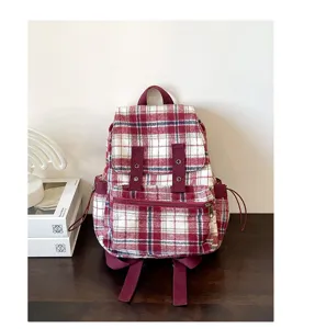 Detailed view of the vintage plaid backpack featuring textured fabric and adjustable straps.