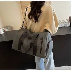 Vue détaillée du grand sac de voyage gris montrant la poche latérale et les sangles.