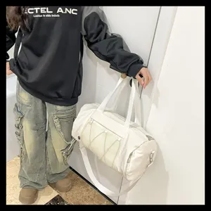 White sports gym duffel bag detail showcasing mesh pocket, adjustable strap and spacious interior.