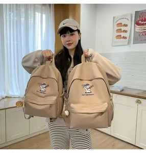 Detailed view of large capacity canvas backpack with cute puppy embroidery for student travel.