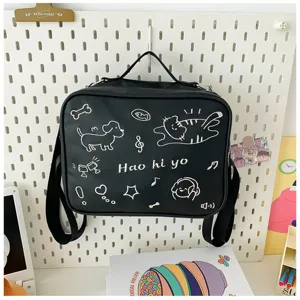 Detailed view of the black canvas ita doll bag featuring cute white cat embroidery and doodles.