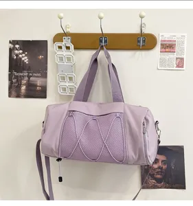 Lightweight sports gym bag detail, purple duffel bag with mesh pocket and shoulder strap.