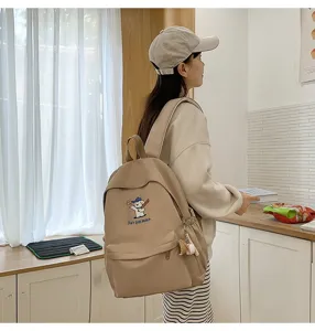 Detail view of the cute embroidered puppy backpack in a clean lifestyle kitchen setting.