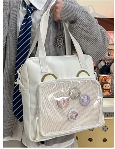 White PU ita shoulder bag with transparent pocket and bear ears for anime badges and pins.