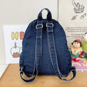 Dark blue denim backpack, casual student daypack with adjustable straps and top handle detail.