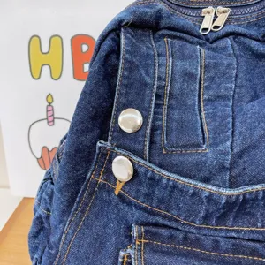 Denim backpack detail with contrast stitching and metal buttons, vintage style student book bag.