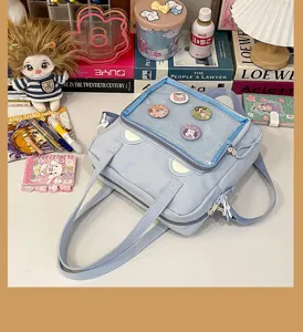 Clear window ita bag detail shot, light blue student shoulder bag with cute bear ears design.