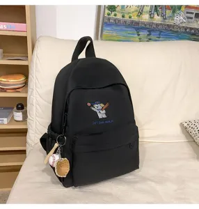 Black canvas school backpack with cute baseball puppy embroidery and pendant for girls travel.