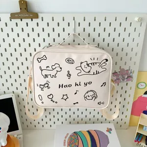 Cute doodle canvas messenger bag detail showing cat and dog print design and adjustable strap.