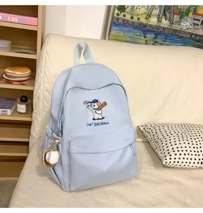 Detailed view of the cute embroidered dog backpack pocket, showing fine stitching and casual style.
