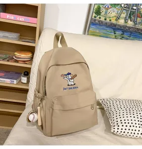 Beige canvas backpack with cute puppy embroidery and large capacity for daily school commute.