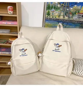 Cute embroidered puppy detail on a stylish white canvas backpack, perfect for daily student travel.