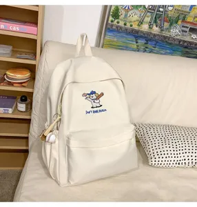 White casual backpack detail featuring cute dog embroidery and spacious design for daily use.