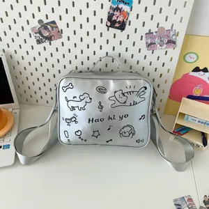 Silver cute ita bag detail view featuring adorable cat dog doodle print and shoulder strap.