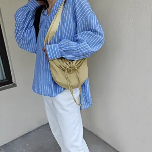 Casual nylon crossbody dumpling bag with drawstring design for everyday trendy street style look.