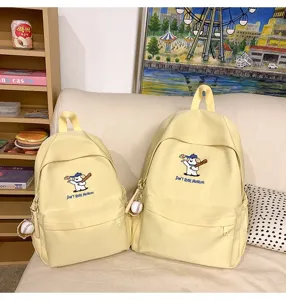 Yellow canvas school backpack set for students, cute embroidered dog pattern with baseball charm.