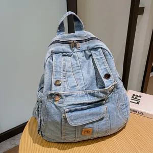 Detailed view of retro denim backpack for women, casual vintage student bookbag for travel.