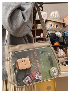 Beige nylon ita bag with clear window, perfect for pins, badges, and daily casual crossbody wear.
