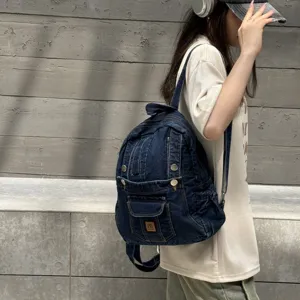 Stylish dark blue denim backpack for women, casual daily travel school book bag with pockets.