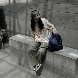 Detailed view of vintage denim backpack with multiple pockets, casual street style design.