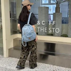 Vintage denim backpack for women, casual college school bag, retro style travel daypack.