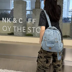 Detailed view of vintage denim backpack, multi-pocket casual school bag with retro wash design.