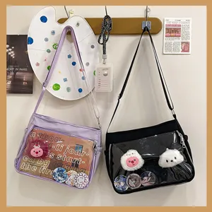 Detail view of canvas ita cross-body bag featuring a transparent front pocket for badge display.