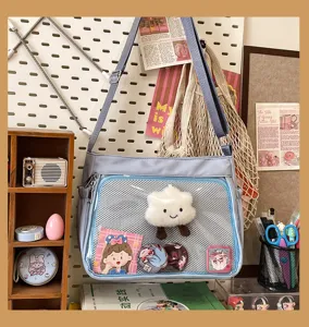 Detailed view of the light blue ita bag featuring a clear front mesh pocket and cute decor.