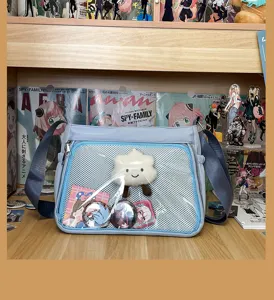 Detailed view of the cute ACG transparent ita bag featuring badge display window and blue strap.