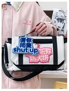 Detail shot of the anime pain bag with funny badges, large capacity shoulder messenger bag.
