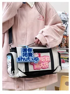 Detailed view of the anime ita bag with transparent side pocket, badge display area, and fun slogan charms.