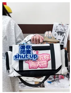 Close-up detail of the anime style itabag, showing unique slogan badges and black-white contrast.