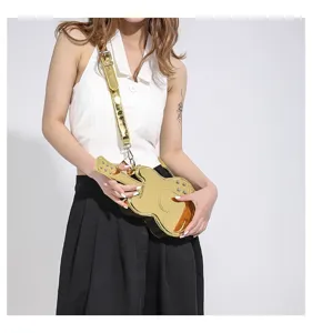 Detailed shot of unique gold shiny guitar shaped shoulder bag, showcasing trendy metallic texture.