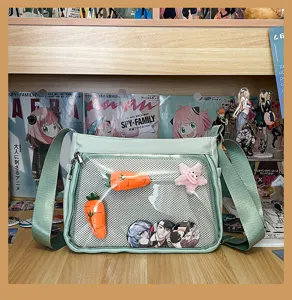 Light green ita bag with clear mesh pocket, cute anime badge display crossbody bag for fans.