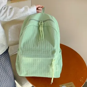 Sac à dos décontracté vert clair grande capacité, idéal pour les voyages et les études.