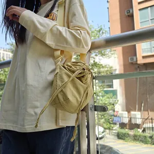 Casual nylon drawstring crossbody bag, trendy large capacity dumpling style daily shoulder bag.