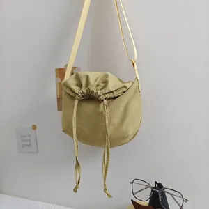 Nylon crossbody dumpling bag with drawstring closure, casual shoulder bag for daily use.