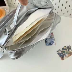 Silver metallic ita bag detail view, multi-compartment anime shoulder bag with card slots.