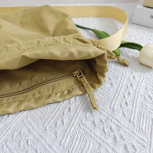 Large capacity nylon messenger bag in khaki, featuring durable fabric, wide strap and zipper.