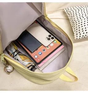 Detailed view showing large capacity and multi-compartment storage inside the canvas backpack.