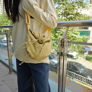 Casual large capacity nylon crossbody bag, unisex street style drawstring dumpling bag for daily wear.