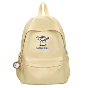 Light yellow canvas backpack with cute puppy embroidery and baseball pendant, front view.