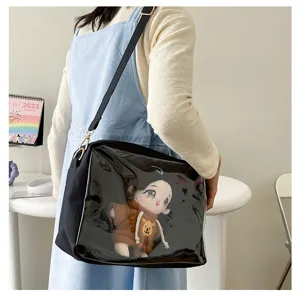 Detail view of Japanese Harajuku style black clear ita bag with cute plush doll inside.