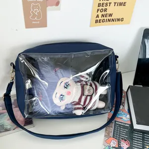 Detailed view of navy blue ita bag with clear window showing a cute doll. Perfect for anime fans.